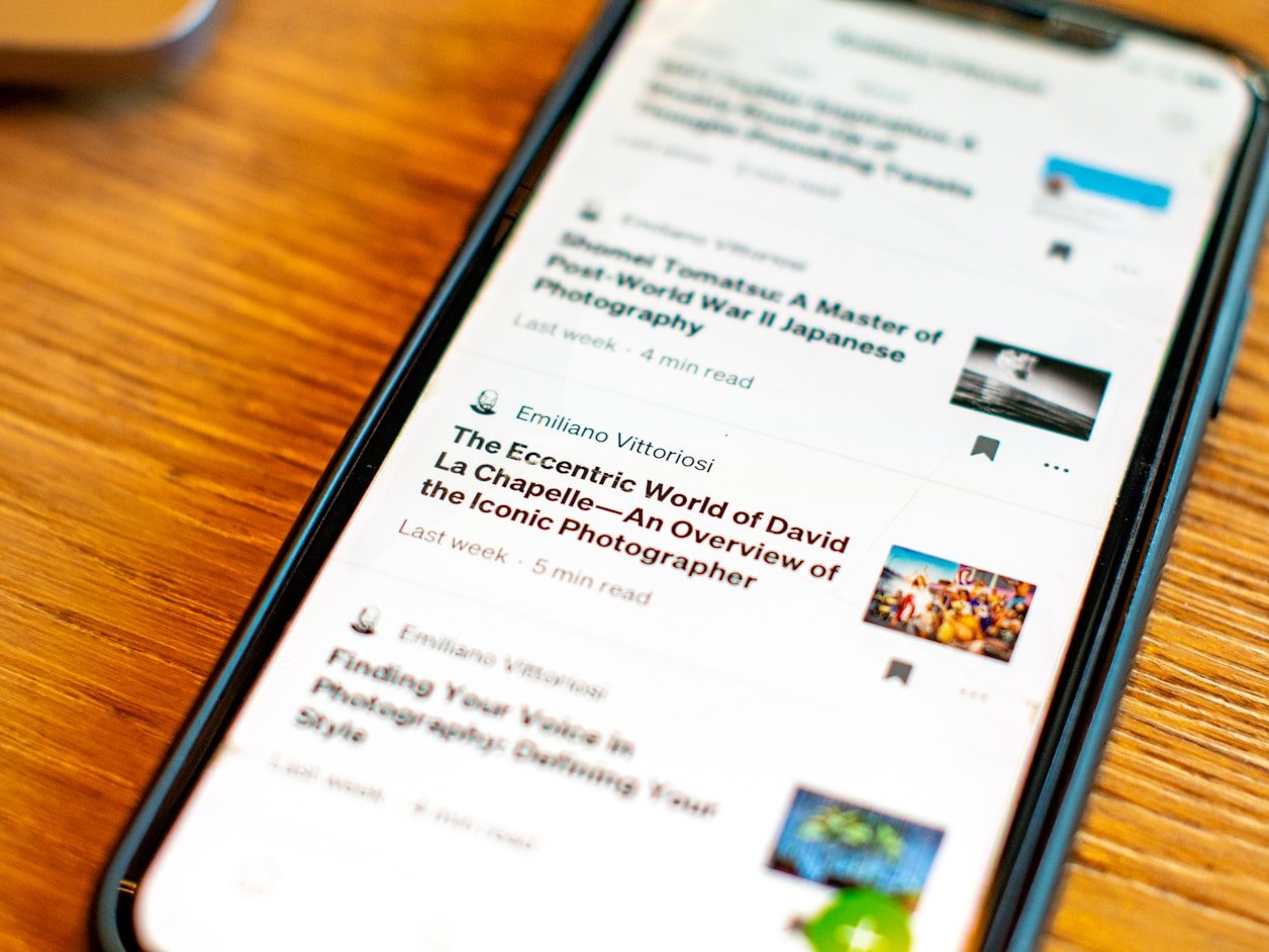 Tablet displaying news articles on a wooden desk
