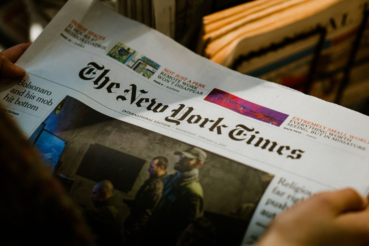 Stack of folded newspapers on a wooden surface
