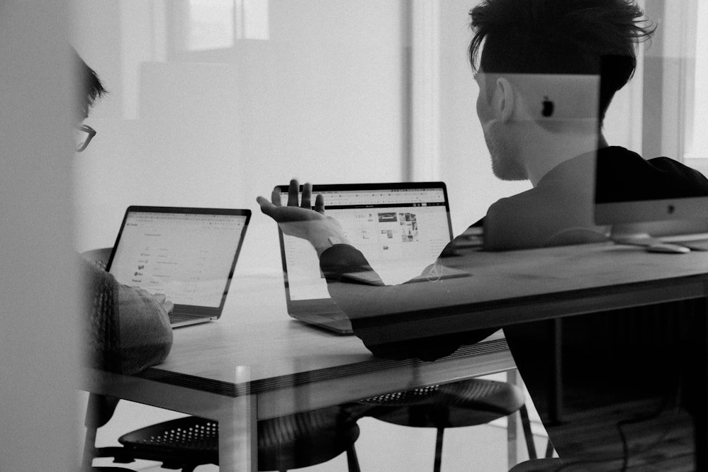 Engineering team pair programming at a workstation