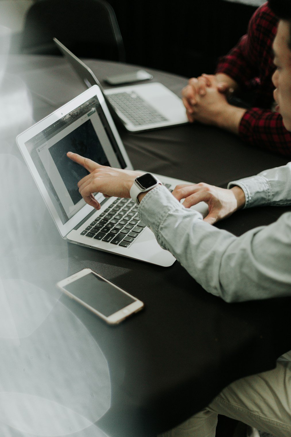 Designer reviewing UI screens on a laptop